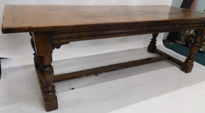 An oak refectory table in 17thC style, the rectangular planked top with a moulded frieze on turned supports, with flat H stretcher, 77cm high, 230cm wide, 91cm deep. - 4