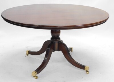 A reproduction mahogany dining table, the circular cross banded top on a turned column and four splayed legs with brass castors, 75cm high, 136cm diameter, and a set of six regency style dining chairs, with padded back and seat, on sabre legs. - 2