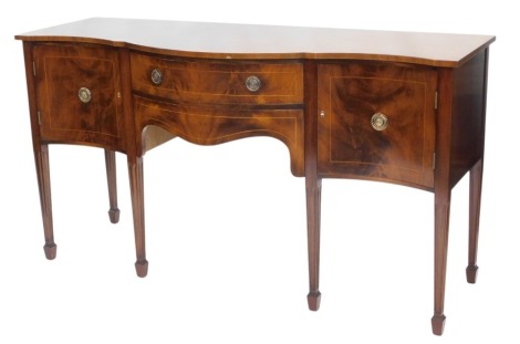 A George III style mahogany sideboard, the cross banded top with serpentine front above an arrangement of two baize lined drawers, and two doors, on channelled square tapering legs, 93cm high, 170cm wide.