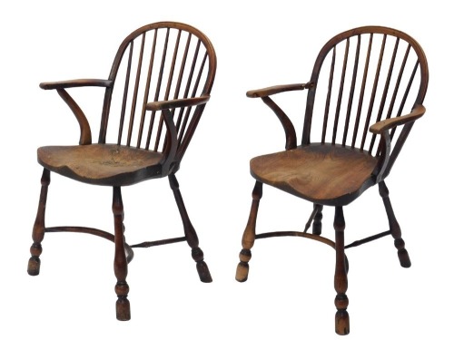 A pair of 19thC yew and elm Windsor armchairs, each with a spindle turned back, solid seat and turned legs with crinoline stretcher. (AF)