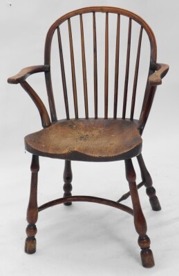 A pair of 19thC yew and elm Windsor armchairs, each with a spindle turned back, solid seat and turned legs with crinoline stretcher. (AF) - 2