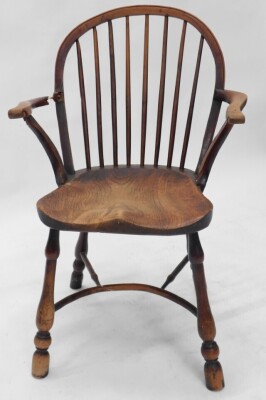 A pair of 19thC yew and elm Windsor armchairs, each with a spindle turned back, solid seat and turned legs with crinoline stretcher. (AF) - 5