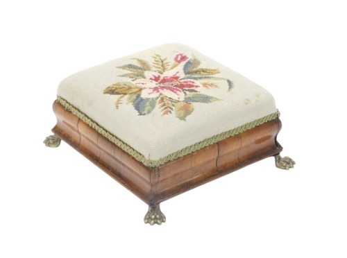 A Victorian rosewood footstool, needlework padded seat, moulded sides and brass paw feet, 36cm wide.