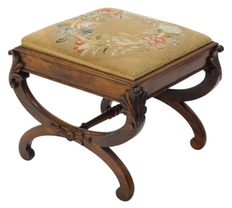 A Victorian rosewood stool, the top in contemporary woolwork padded seat, on carved X shaped supports, 48cm wide.