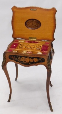 A 19thC Continental walnut and floral marquetry work table, with gilt metal mounts, the hinged quarter veneered kingwood crossbanded top enclosing a fitted interior, on cabriole legs with sabot, 71cm high, 52cm wide. - 2