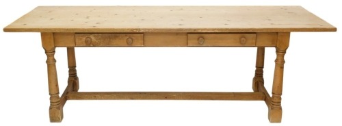 A large pine refectory table, the rectangular planked top on turned supports with low H stretcher, 78cm high, 246cm wide, 82.5cm deep.