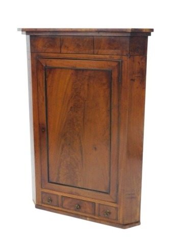 A 19thC mahogany and ebony strung corner cabinet, with a moulded cornice above a single panelled door and three drawers, 122cm high, 88cm wide.