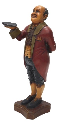 A carved and painted footman or waiter figure, on a concave base, 102cm high.