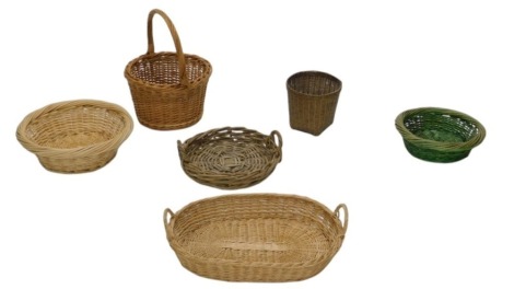 A collection of baskets, to include a dark coloured basket with loop handle.