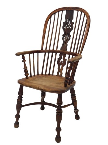 A 19thC yew ash and elm Windsor chair, with a pierced splat, spindle turned supports, and a solid seat, on turned legs with crinoline stretcher.