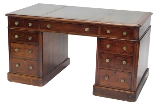 A Victorian mahogany pedestal desk, the rectangular top with a green leather insert above an arrangement of nine drawers, with brass handles, on a plinth, 75cm high, 140cm wide.