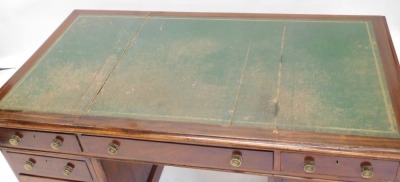 A Victorian mahogany pedestal desk, the rectangular top with a green leather insert above an arrangement of nine drawers, with brass handles, on a plinth, 75cm high, 140cm wide. - 2