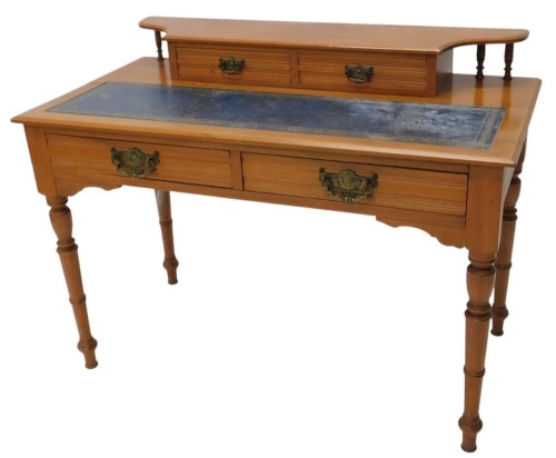 A Victorian walnut writing desk, the top with a raised section with two drawers and a blue leather insert above two frieze drawers, on turned legs, 82cm high, 107cm wide.