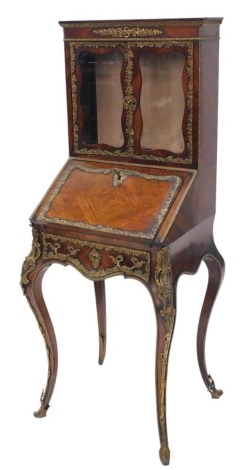 A 19thC Continental rosewood and gilt metal bureau cabinet, the top with two glazed doors, the base with a shaped quarter veneered fall enclosing a fitted interior with a well, on cabriole legs, possibly French, 135cm high, 55cm wide.