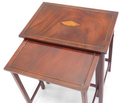 A nest of two reproduction mahogany tables, the largest inlaid with a marquetry shell, 51cm wide. - 2