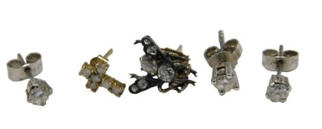 A pair of diamond ear studs, an odd diamond stud, crucifix stud, a 'bee' ear stud, etc.