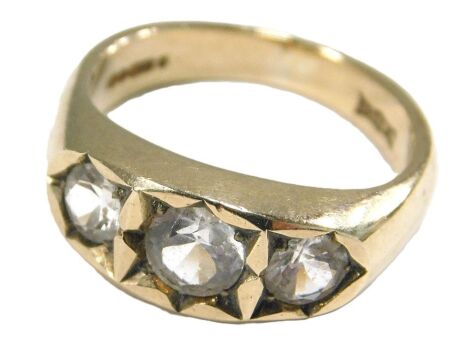 A 9ct gold and zirconia three stone ring, in a rub over setting, size P, 6.6g.