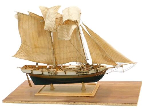 A scratch built model of a two masted sailing ship, on rectangular base, 88cm long.