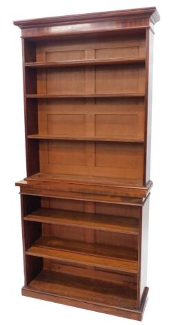 A Victorian open bookcase, the top with a moulded cornice above three adjustable shelves, the base with a further two adjustable shelves on a plinth, 207cm high, 96cm wide.