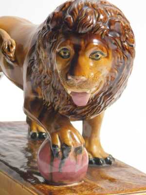 An early 19thC brown glazed Staffordshire lion, After Ralph Wood, with the front right paw resting on a magenta coloured ball, on a rectangular base, 33cm long. - 5