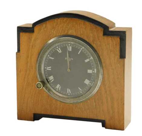 An Art Deco oak cased eight day mantel clock, the dial possibly from a car.