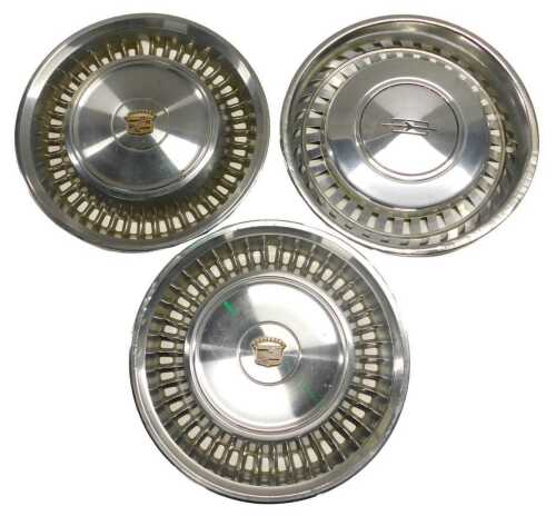 Two Cadillac chrome hub cap covers and an Oldsmobile chrome hub cap cover. (3)