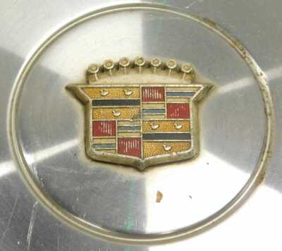 Two Cadillac chrome hub cap covers and an Oldsmobile chrome hub cap cover. (3) - 3