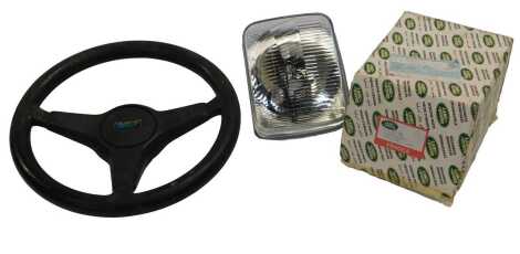 An Austin steering wheel, and a Land Rover 1XSTC766 head lamp assembly left hand. (2)