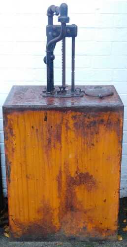 A Gilbert and Barker MFG Company oil pump cabinet, in orange, 123cm high.