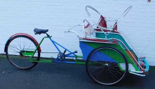 An Eastern rickshaw, with partial canopy, 145cm high.