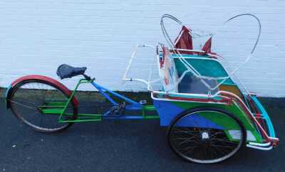 An Eastern rickshaw, with partial canopy, 145cm high. - 2