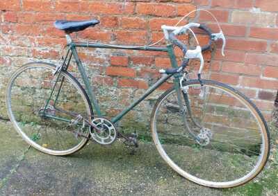 A FJ Sanders time trial bike, in green trim, with two additional wheels, together with a Curly Hetchins bicycle frame, in green, lacking wheels, frame no. J77-66. - 2