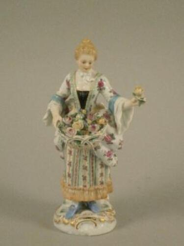 A Meissen porcelain figure of a lady with a basket of flowers