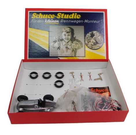 A Schuco Studio 1936 Mercedes Benz race car, in silver, together with accessories, boxed.