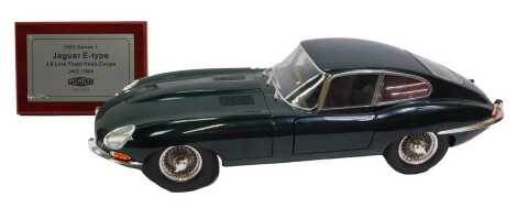 A Deagnosti 1963 Series 1 Jaguar E Type 3.8 litre fixed head coupe, with associated Jaguar Heritage plate.