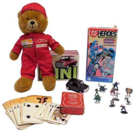 A Corgi Mini 1959-1989 limited edition Mini Cooper, a DC Heroes metal figure set Justice League of American Advisories, a Park Lane plastic finish playing cards, and a Michael Schumacher Teddy bear. (4)