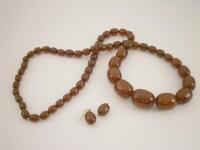 A graduated amber bead necklace and earrings