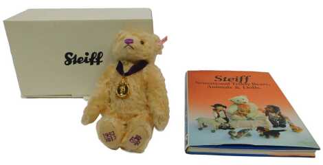 A Steiff Queen Elizabeth II Diamond Jubilee Bear 1952-2012, 27cm high, blonde mohair, boxed with certificate, and a Steiff Sensational Teddy Bears Animals and Dolls reference book by Pistorius. (2)