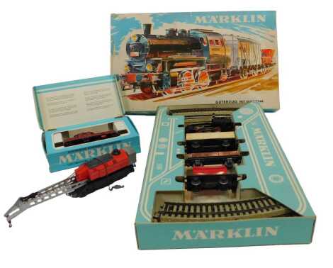 A Marklin HO gauge 3001 locomotive 6302 of the Deutsche Bahn Railway, a Marklin 3200 DB Goods train set with locomotive, box car and other rolling stock, and a Lilliput HO gauge locomotive train. (3)