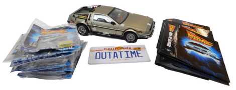 An Eagle Moss Collections Build the Back to the Future Delorean, including a kit built DMC Delorean, magazines, spare parts, etc. (a quantity)