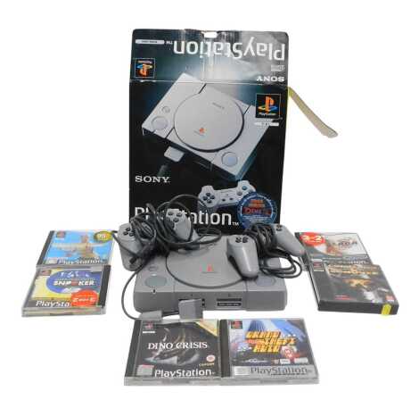 A Sony PlayStation Model SCPH1002, with a dual shock controller, and an analogue controller, including games Anna Kournikova's Smash Court Tennis, World Championship Snooker, Brian Lara Cricket, Dino Crisis, Grand Theft Auto, and Command and Conquer.