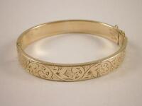 A yellow metal bangle