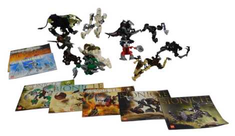 A group of Lego Bionicles figures, to include Panrahk, Pohatu, etc., some with associated leaflets.