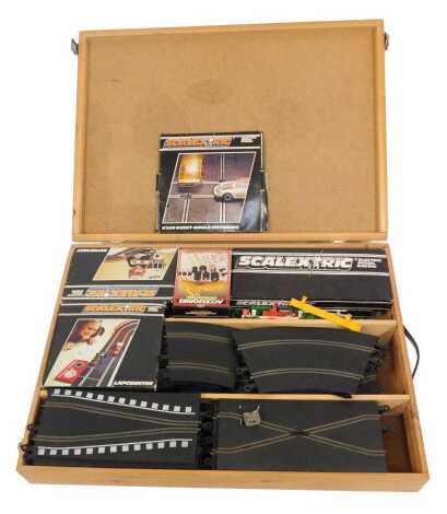 A group of Scalextric, including a hump bridge, auto start, lap counter, tracks, and railing, some boxed, with outer casing.