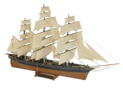 A scale model of the Cutty Sark, fully rigged under sail.