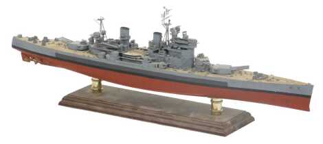 A wooden and plastic scale model of a World War II battleship, on a cradle stand, 65cm wide.