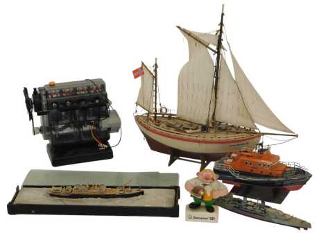 A scale model of a 19thC passenger ship, World War II battleship, a lifeboat, a wooden Norwegian sailing ship Colin Archer, and a Hornby combustion engine.