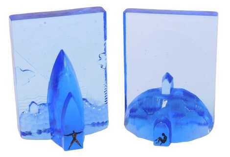 A pair of Kosta Boda blue glass sculptural bookends, designed by Betil Vallien, numbers 7091008 and 7091009, etched marks, 15.5cm high.