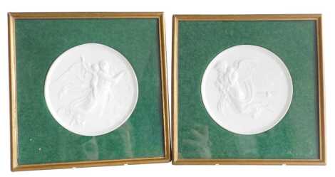 A pair of Bing & Grondahl bisque circular porcelain plaques, emblematic of The Night, and The Day, designed by Bertl Thorvaldsen, framed and glazed, plaques 14cm wide.