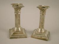 A pair of silver Corinthian column candlesticks